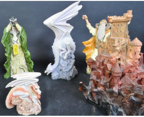 A collection of vintage 20th century Enchantica resin figurines comprising of a Wizard holding a globe, two globes a castle a