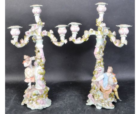 A pair of 19th century German Sitzendorf porcelain candelabra. Each having three arms with floral encrustations all over w3it