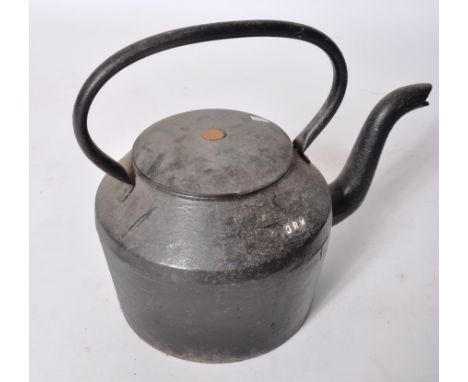 A 19th century Victorian cast iron railway crew tea pot of large proportions. Black cast iron body with wooden lid and handle