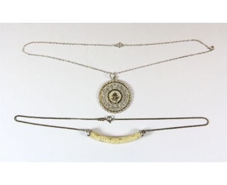 A Chinese silver pendant and a Chinese carved bone and silver necklace