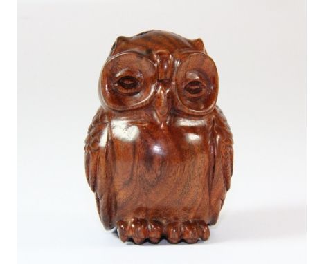 A carved hardwood netsuke of an owl, H 6cm
