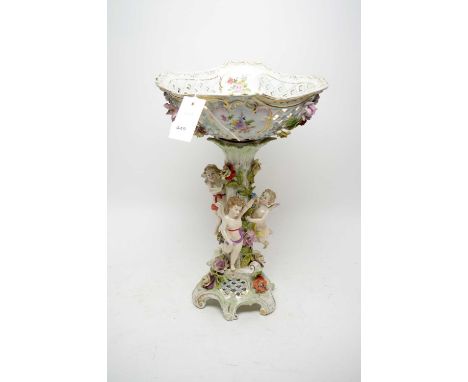 A Meissen style ceramic pedestal comport, the pierced and floral encrusted bowl raised over a pillar encrusted with flowering