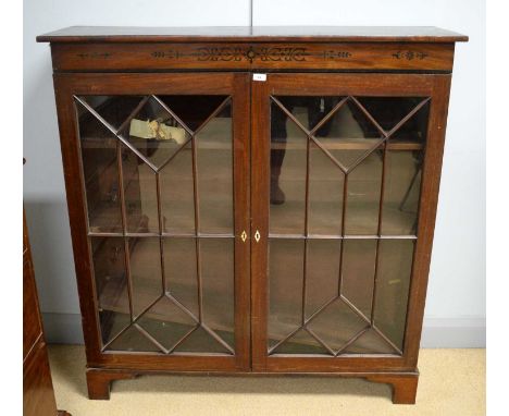 A mahogany glazed bookcase (formerly the upper section to a larger bookcase), the rectangular top above an inlaid frieze, a p