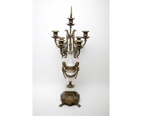 An Italian marble and brass six-branch candelabra, with griffin and putti motif decoration, 69cms high.
