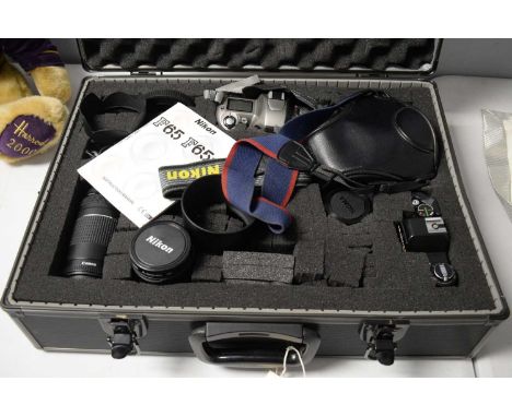 A collection of cameras, lenses and camera accessories, including: Nikon F65 camera, with instruction manual; Canon EOS 300; 