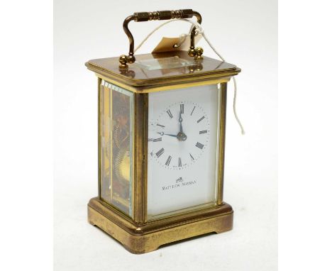 A 20th Century Matthew Norman brass carriage clock, with white enamel Roman dial, platform lever escapement, 14.5cms high (in
