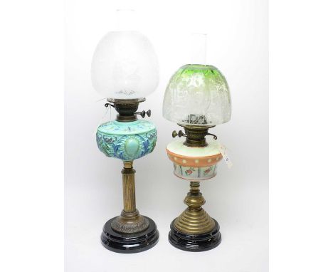 A Victorian glass oil lamp, with painted blue glass reservoir, 69cms high including shade and funnel; together with another o