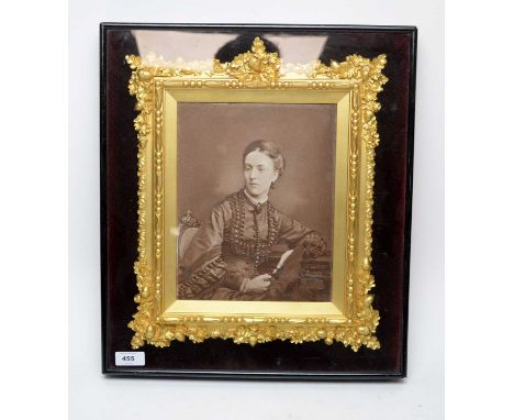 A late Victorian photographic portrait of a lady, c.1870, in a gilt frame incorporating oak leaves and acorns, contained with