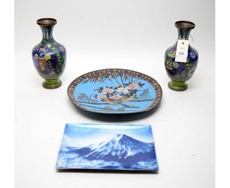 A pair of Chinese cloisonné enamel vases, each decorated with panels of vases, pots and plates, 24cms high; together with a J