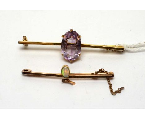 An amethyst brooch, the oval facet cut amethyst set in 9ct yellow gold; and an opal brooch, in 9ct gold mount. 