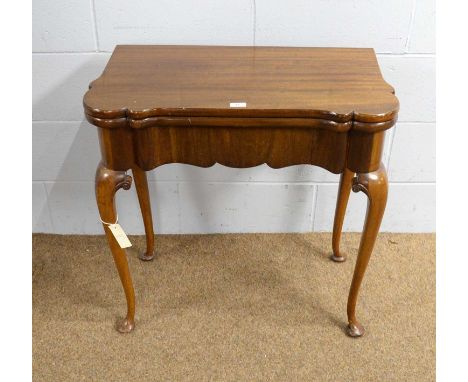 A Georgian-style mahogany card table, the hinged, swivel top opening to reveal a blue baize lined playing surface, shaped apr