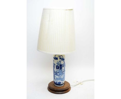 A Chinese blue and white ceramic table lamp, raised on a circular stained wood base, with shade, 53cms high overall.