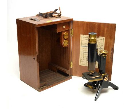 A brass lacquered students microscope, with applied brass plaque inscribed ‘R. Clark Newcastle’, in stained wood carry case.