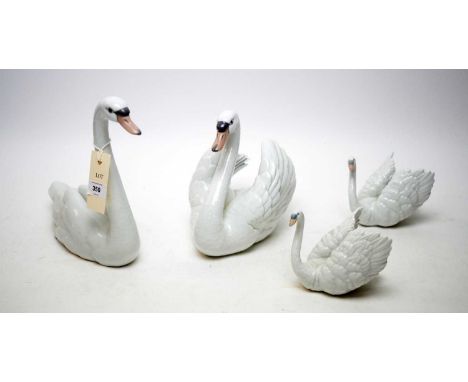 A collection of four Lladro decorative ceramic swan figures, the tallest 22cms high.