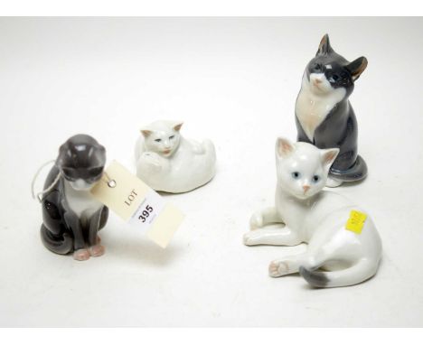 A collection of four Royal Copenhagen ceramic cat figures, of various breeds and sizes, the tallest 14cms high.