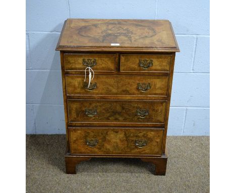 An attractive small burr walnut chest in the early 18th Century taste, the rectangular banded and moulded top above two short