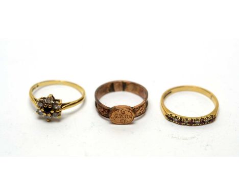 A 9ct yellow gold and plaited hair mourning ring; a ruby and diamond ring; and a red and white stone cluster ring. 
