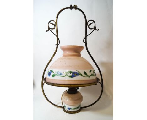A Victorian hanging oil lamp with glass reservoir and shade, painted with flowers on a pink ground, overall 59cm