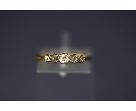 An early 20th century  gold and diamond five stone ring, the graduated old-cut stones approx 0.40 cts total, claw set in gold