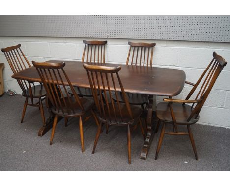 A set of six Ercol stick back dining chairs and an Ercol refectory style table, 72cm high x 176cm long x 77cm deep