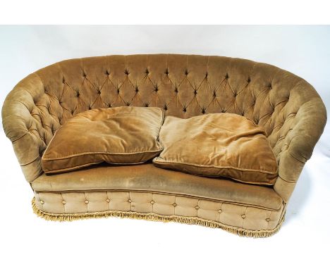 A 1930's button back sofa with curved back, 168cm wide