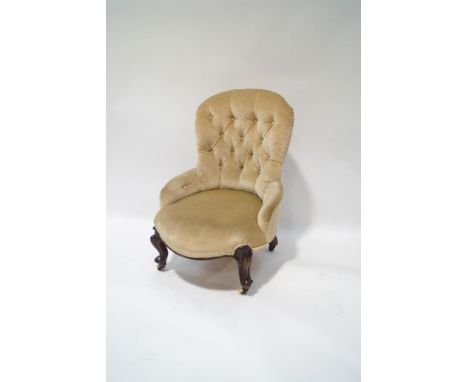 A Victorian mahogany button back chair on scroll legs