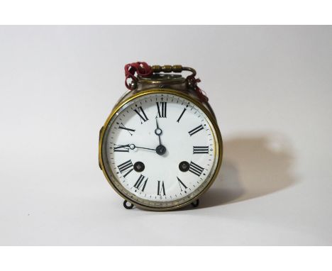 A brass drum alarm clock with visible escapement, 13cm high including handle, with winding key