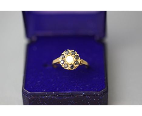 A 9 carat gold opal and sapphire cluster ring, finger size Q1/2, 2.7 g gross, cased