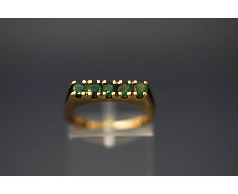 A 9 carat gold five stone emerald ring, finger size L, 2.7 g gross