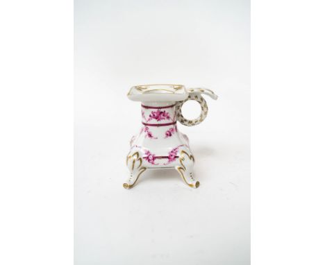 A Dresden porcelain candlestick, decorated with garlands of roses and gilt detail, painted factory marks, 9cm high