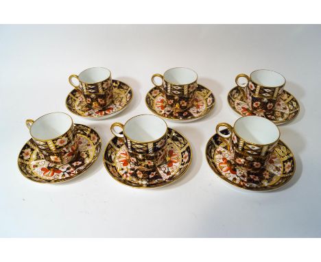 A set of six Royal Crown Derby coffee cups and saucers, in the Imari pattern, red printed factory marks