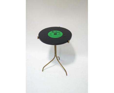 A mid 1960's occasional table, the top in the form of a Beatles record, Hard Days Night, 65cm high x 45cm diameter