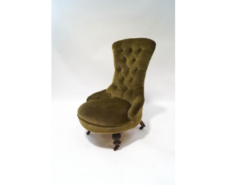 A Victorian mahogany button back chair on turned and carved legs