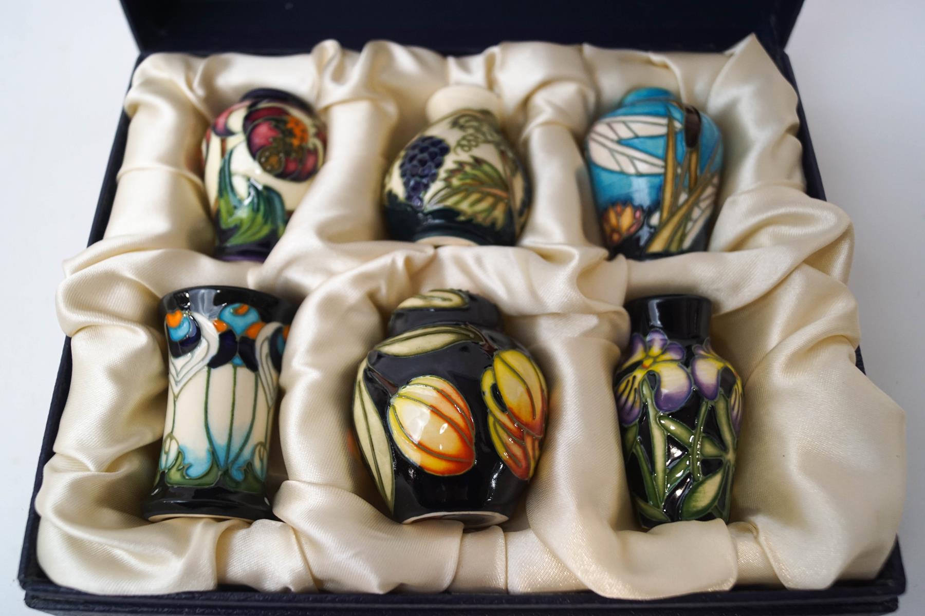 A set of six miniature Moorcroft vases, boxed