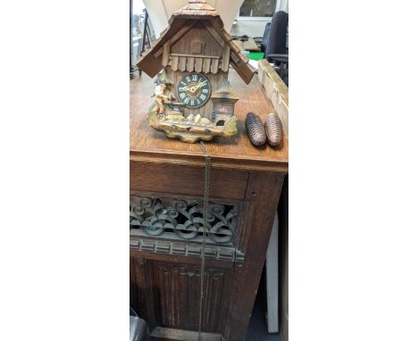 A vintage Black Forest Cuckoo clock in the style of architectural form, together with two weightsLocation: 
