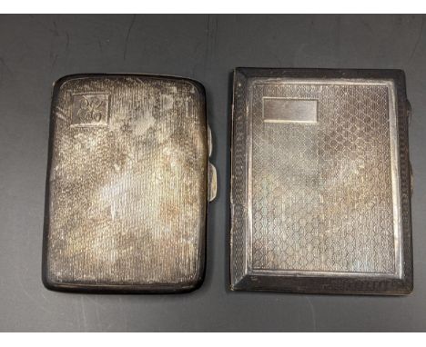 Two early 20th century silver cigarette cases having engine turned decoration, one with initials, 124.2gLocation: 