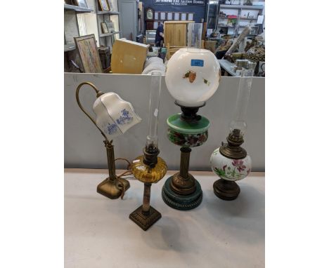 A late 19th/early 20th century oil lamp together with two others along with a brass lampLocation: 