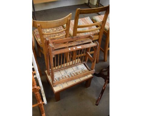 A small tile topped table and a wooden plate rack