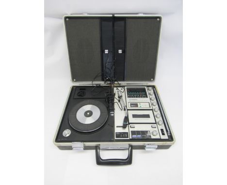 A 1970s Sanyo G-2311KL Solid State Music Centre portable record player with speaker lid