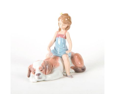 Glossy porcelain; young girl playing with her Mastiff dog. Includes original box. Lladro backstamp. Artist: Juan HuertaIssued