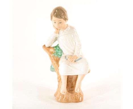 Glazed porcelain figure; Young boy dressed in white; sitting on branch. No box. Issued: 1974-1993Dimensions: 8.25"HManufactur