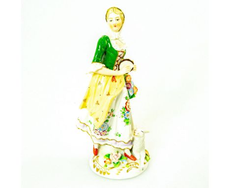 German porcelain; shepherdess playing tambourine with lamb laying by her feet. Green and white coloration; intricate floral d