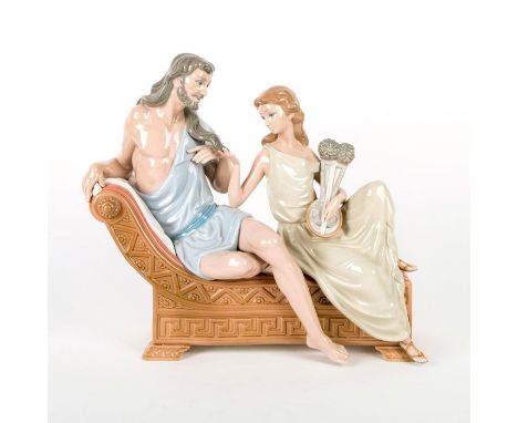 Samson and Delilah sitting on a chair playing with hair. Lladro backstamp. Artist: Vincente MartinezIssued: 1980-1981Dimensio