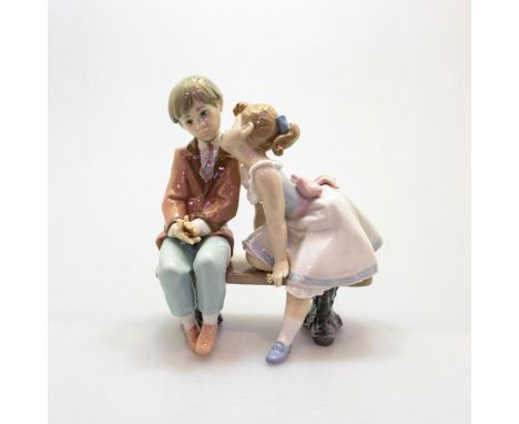 Gres finish figurine. Young boy and girl sitting on bench; light and dark pastels. Lladro backstamp. Artist: Francisco Polope