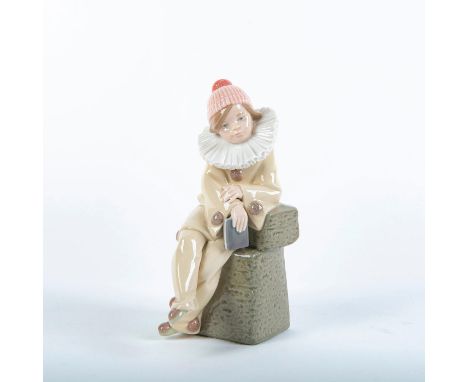 Porcelain figurine with glossy finish; Jester enjoys a moment of peace, seated on a stone bench. Lladro backstamp, does not i