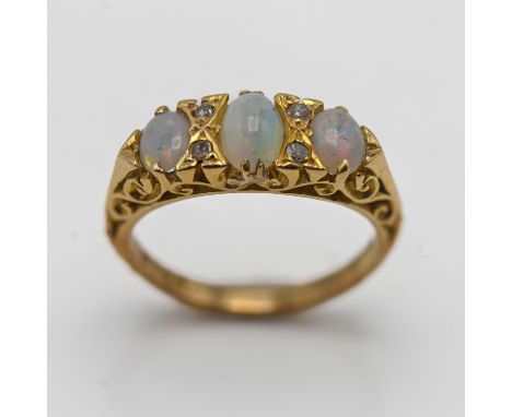 An 18ct yellow gold three stone opal and diamond ring, size J/K.