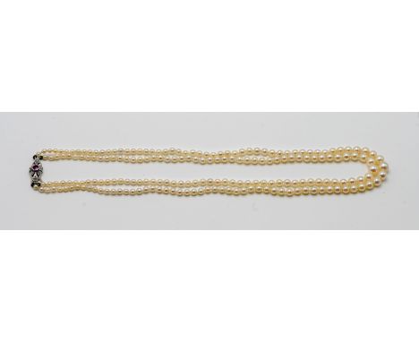 A double row pearl necklace set with ruby clasp.
