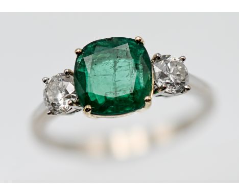 A diamond and rectangular cushion shape emerald three stone ring, the approx. weight of the emerald is 1.24ct, heavily includ