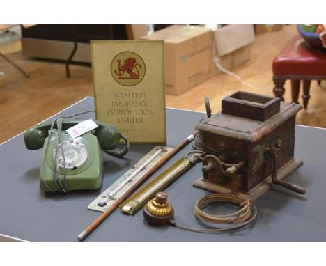 A group including a Victorian sprung service bell with brass push-button, a vintage green telephone, a Royal Marines white-me