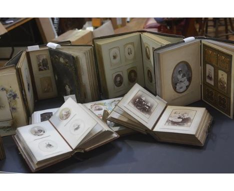 A group of eight Victorian leather-bound photograph albums, each with portrait photographs.